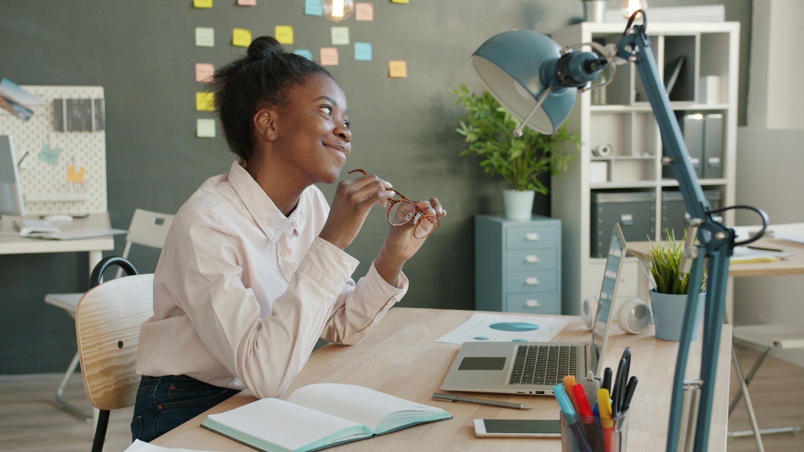 A young woman planning at her desk