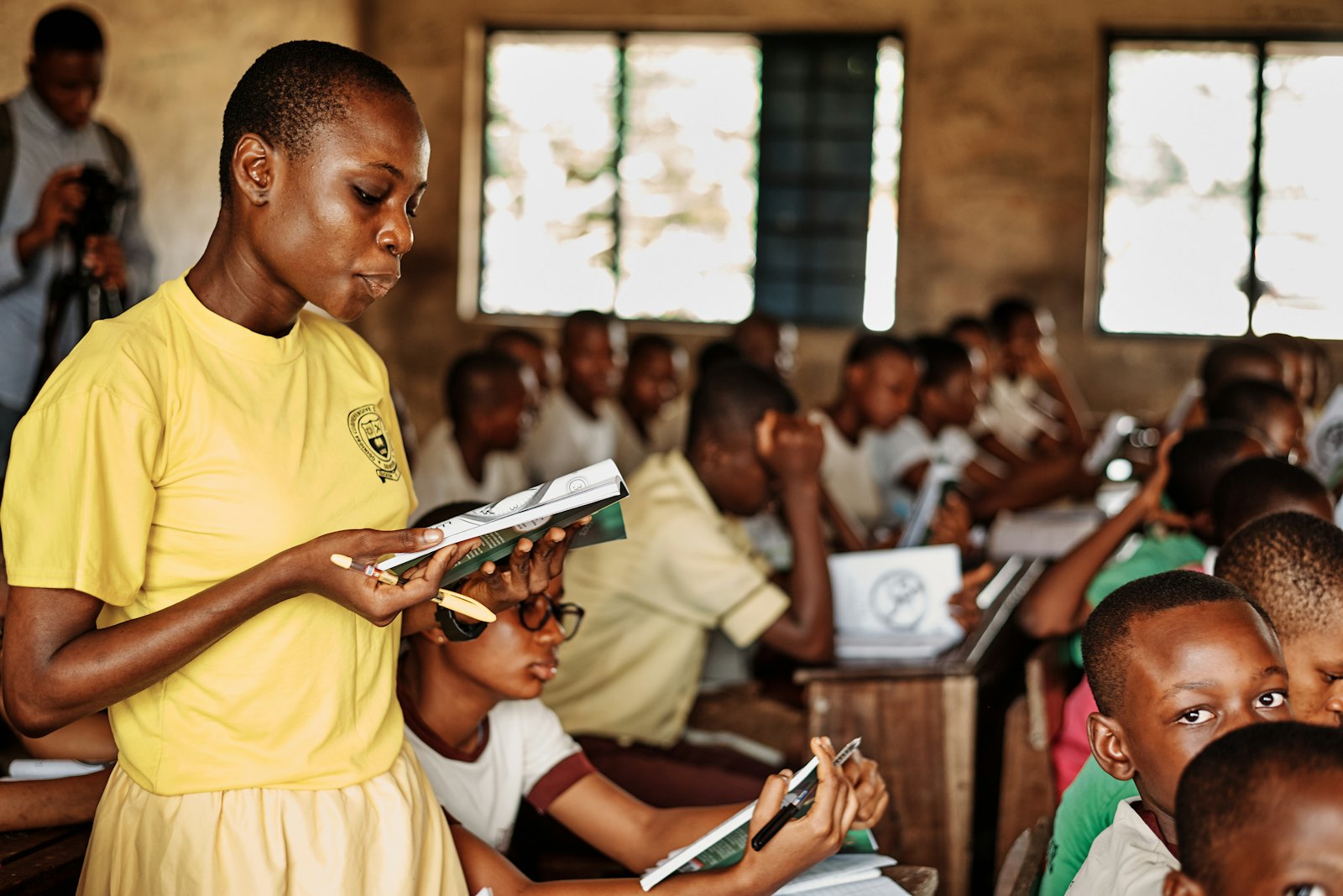 A student reading in a busy classroom