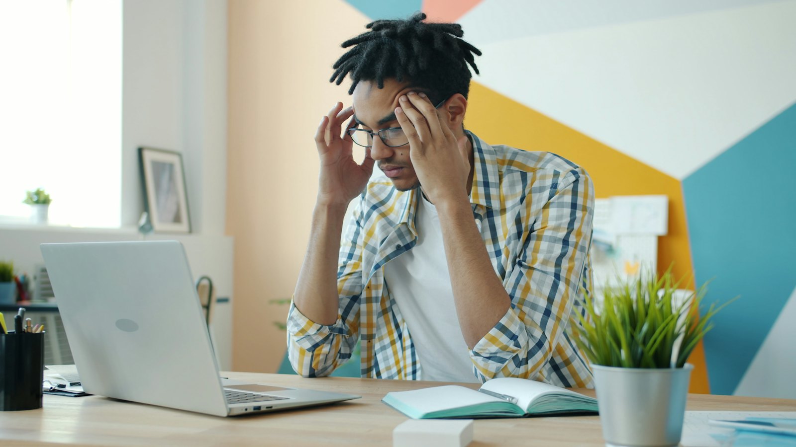 A tired founder at his laptop with his head in his hands