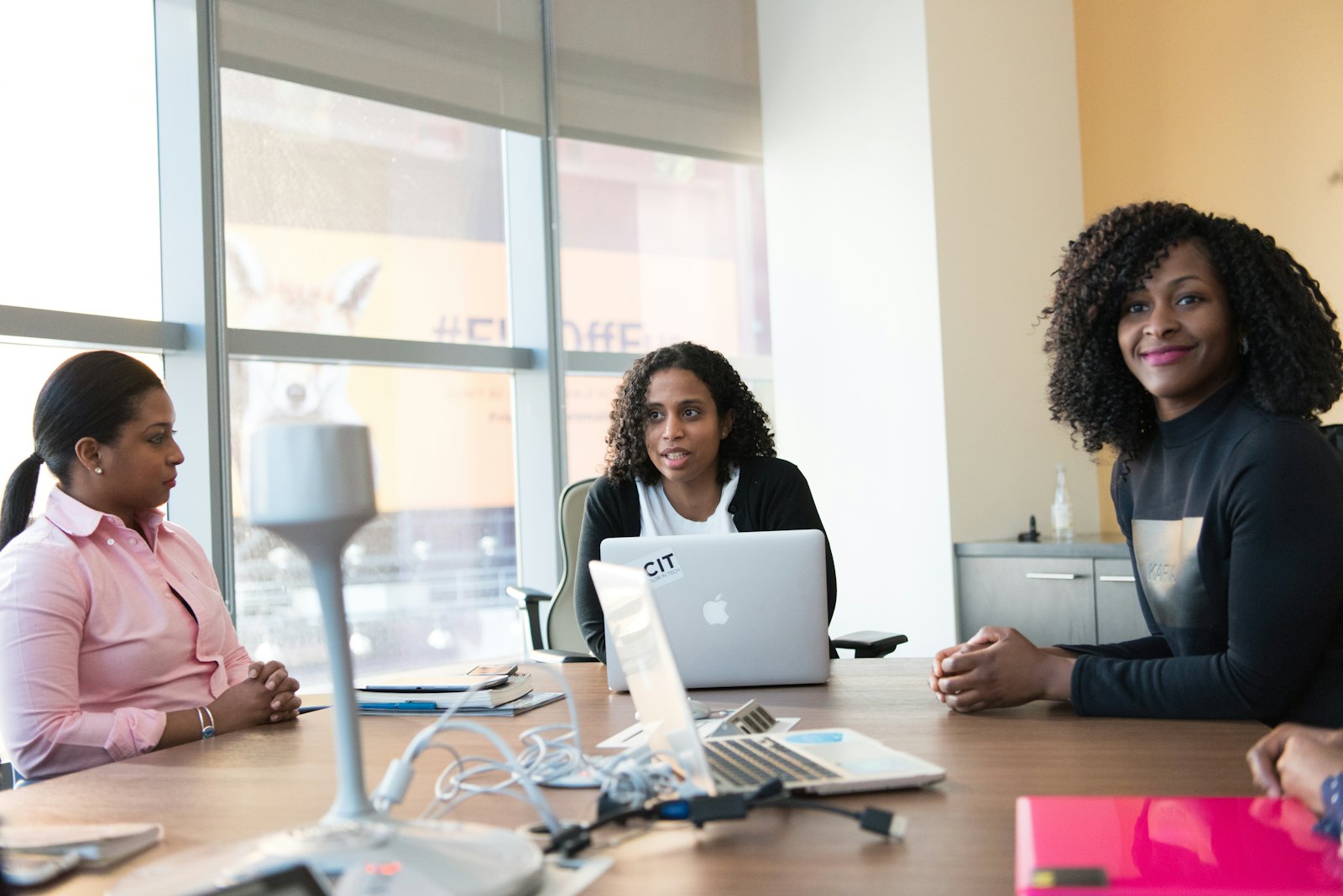 Three colleagues in a meeting at an office table