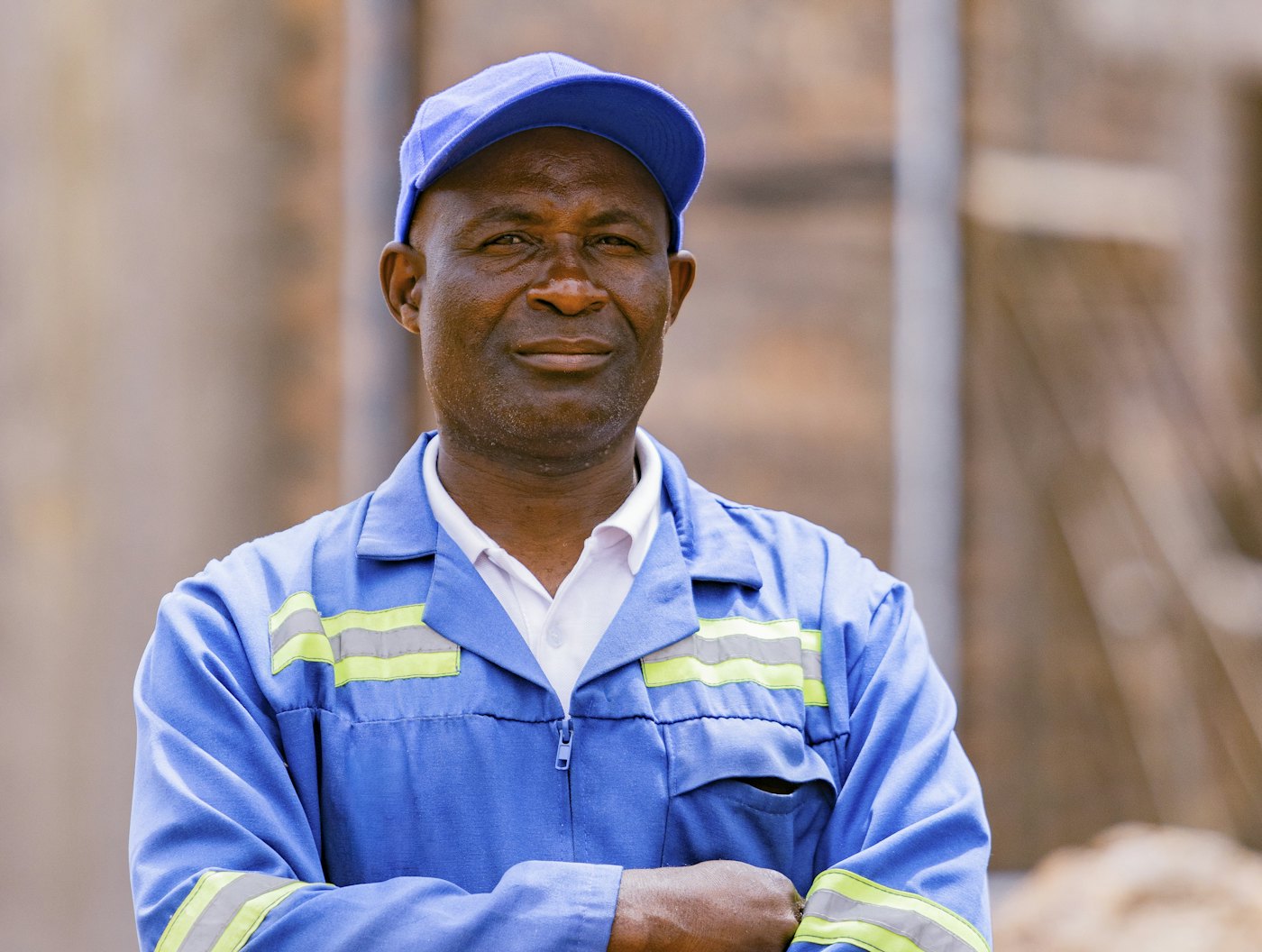 A factory worker in blue overalls