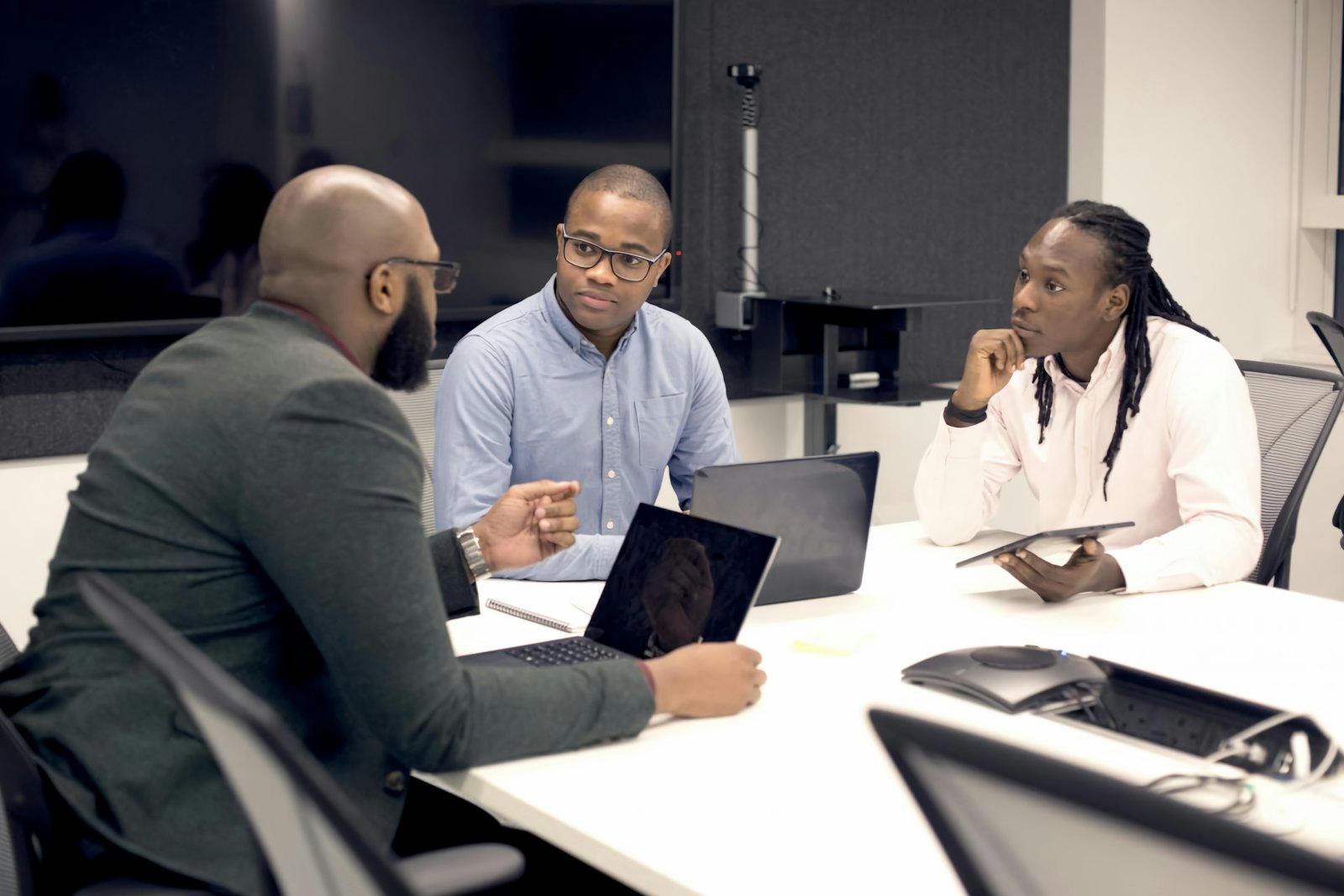 A team working together around a table with laptops